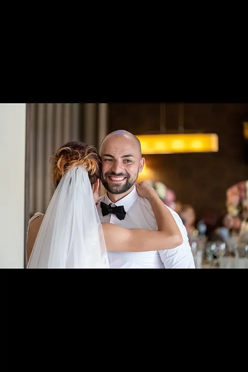 Color wedding photo by Lucas Georgiev. Newlyweds dancing with smile. Place: Lovech, Bulgaria