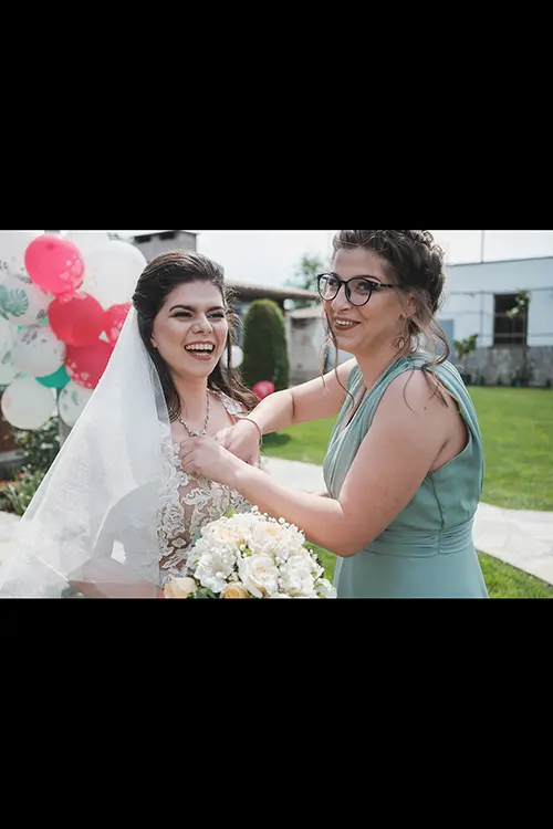 Color wedding photo by Lucas Georgiev. Bride with the bridesmaid funny moment. Place: Trud village, Plovdiv, Bulgaria
